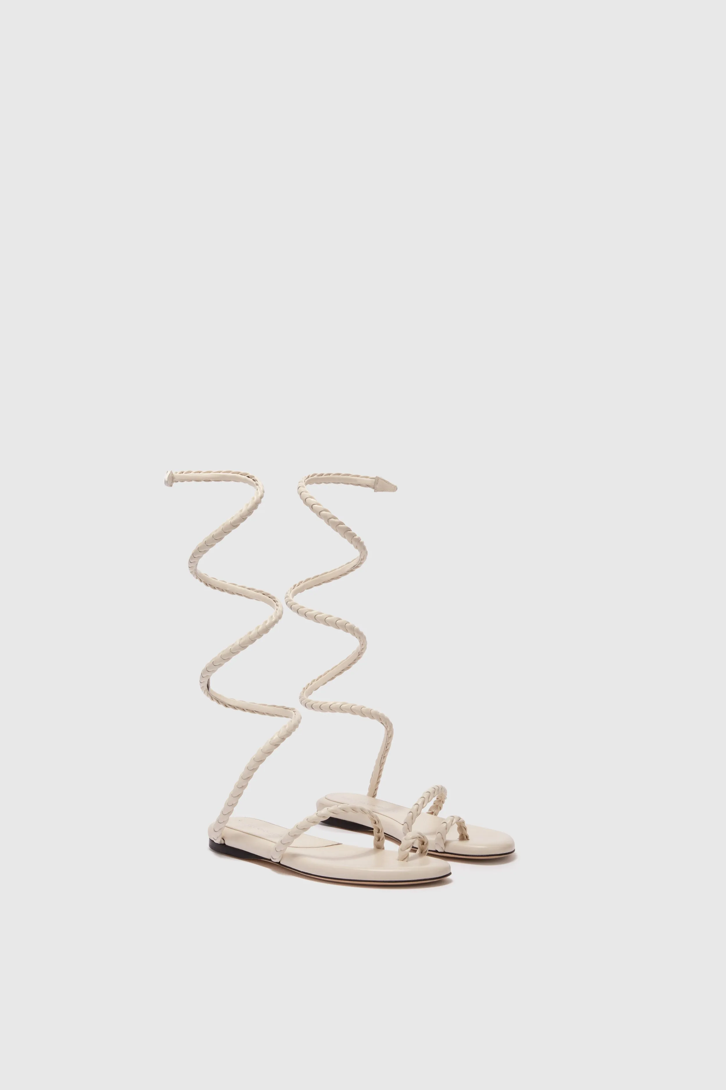 Flat sandal in smooth calfskin with hand-woven lacing