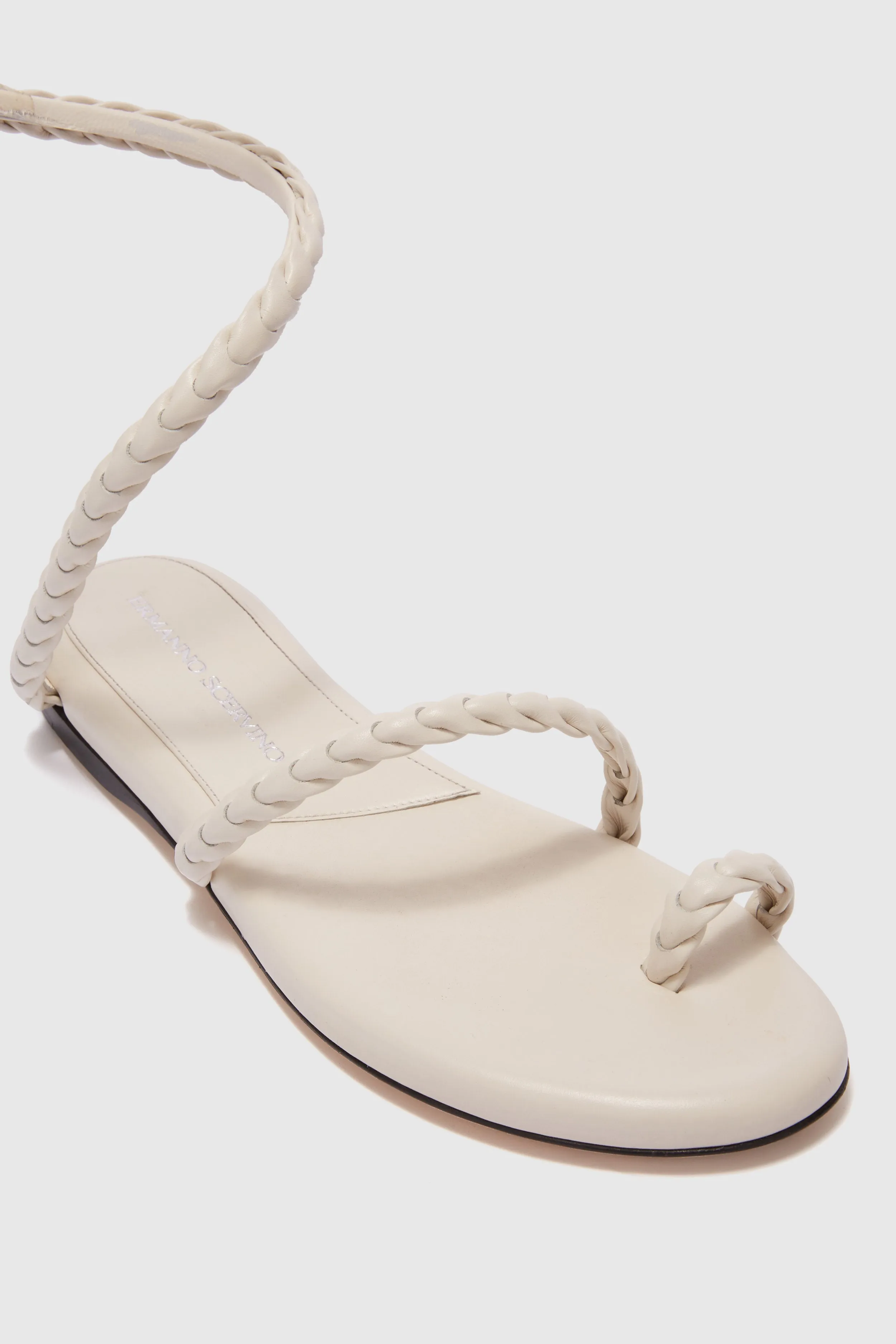 Flat sandal in smooth calfskin with hand-woven lacing
