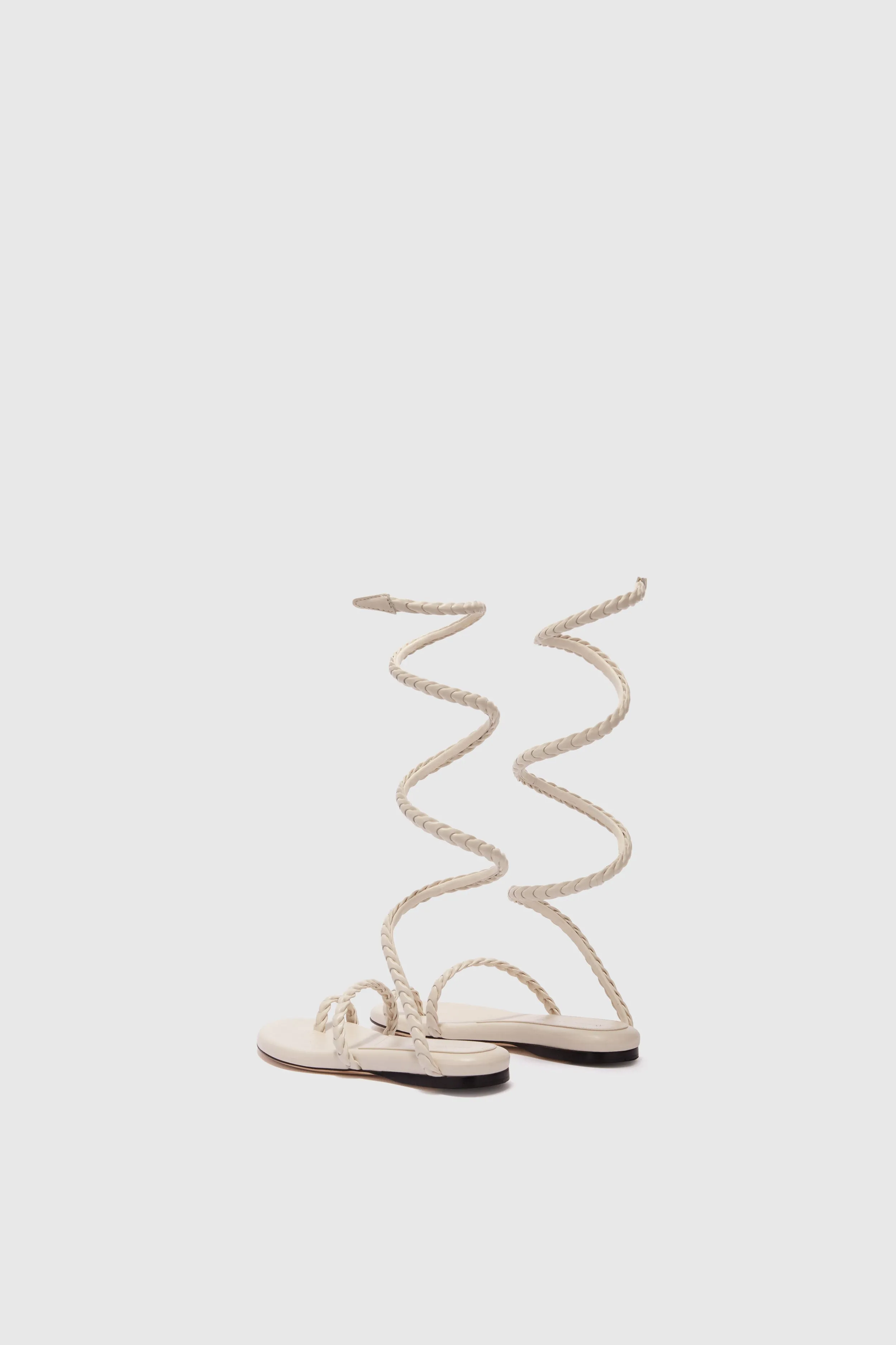 Flat sandal in smooth calfskin with hand-woven lacing